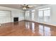Spacious living room with a fireplace, built-in shelving, and plenty of windows at 7854 Springs Village Ln, Charlotte, NC 28226