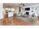 Bright living room featuring a fireplace, built-in shelving, and a ceiling fan at 7854 Springs Village Ln, Charlotte, NC 28226