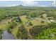 Expansive aerial view of the property, showcasing the lush greenery, pond, and mountain views at 807 And 809 Sparrow Springs Rd, Kings Mountain, NC 28086