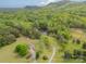 Serene aerial view showcasing a picturesque lake surrounded by lush trees and sprawling grounds at 807 And 809 Sparrow Springs Rd, Kings Mountain, NC 28086