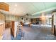Cozy basement features a brick fireplace, wood paneled walls, and carpeted floors at 807 And 809 Sparrow Springs Rd, Kings Mountain, NC 28086