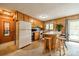 Functional kitchen with wood cabinets, tiled backsplash, breakfast bar, and an adjacent dining area at 807 And 809 Sparrow Springs Rd, Kings Mountain, NC 28086