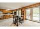 Inviting kitchen and dining area with wood paneled walls and access to the deck at 807 And 809 Sparrow Springs Rd, Kings Mountain, NC 28086