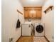 Small laundry room with washer, dryer, and upper cabinet storage at 807 And 809 Sparrow Springs Rd, Kings Mountain, NC 28086