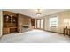 Bright living room showcasing a brick fireplace, built-in bookcases, and balcony access at 807 And 809 Sparrow Springs Rd, Kings Mountain, NC 28086