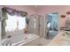 Elegant bathroom showcasing a soaking tub, shower, and soft pink walls with floral accents at 878 Treasure Ct, Fort Mill, SC 29708