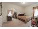 Spacious bedroom featuring neutral walls, carpet, and an archway to a cozy seating area at 878 Treasure Ct, Fort Mill, SC 29708