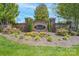 Community entrance with stone walls, flowerbeds, and mature landscaping at 878 Treasure Ct, Fort Mill, SC 29708