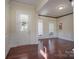 Elegant foyer with hardwood flooring, detailed trim, and a stained glass sidelight window at 878 Treasure Ct, Fort Mill, SC 29708
