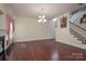Spacious living room featuring hardwood floors, fireplace, and staircase at 878 Treasure Ct, Fort Mill, SC 29708
