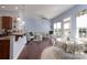 Bright living room features hardwood floors, large windows, and a ceiling fan at 878 Treasure Ct, Fort Mill, SC 29708
