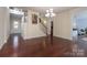 Spacious living room showcasing hardwood floors, open staircase, and a chandelier at 878 Treasure Ct, Fort Mill, SC 29708