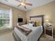 Cozy bedroom with a queen-sized bed, decorative pillows, and natural light from a window at 9727 Glenburn Ln, Charlotte, NC 28278