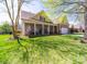 Charming front exterior with manicured lawn, covered porch with columns, and attached garage at 9727 Glenburn Ln, Charlotte, NC 28278