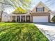Charming brick home with inviting front porch and manicured lawn, a perfect blend of comfort and style at 9727 Glenburn Ln, Charlotte, NC 28278