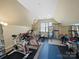 Well-equipped home gym featuring various exercise machines and a padded floor at 9727 Glenburn Ln, Charlotte, NC 28278