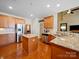 Spacious kitchen with stainless steel appliances, a granite countertop island, and wooden cabinetry at 9727 Glenburn Ln, Charlotte, NC 28278