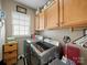 Functional laundry room equipped with a modern washer and dryer, and ample storage cabinets at 9727 Glenburn Ln, Charlotte, NC 28278
