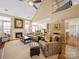 Bright living room features a fireplace, vaulted ceilings, and open layout to the kitchen and dining area at 9727 Glenburn Ln, Charlotte, NC 28278
