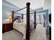 Elegant main bedroom with a four-poster bed, tray ceiling, and bay window seating area at 9727 Glenburn Ln, Charlotte, NC 28278