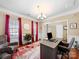 Inviting home office with a modern desk, comfortable seating, and natural light from large windows at 9727 Glenburn Ln, Charlotte, NC 28278