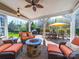 Outdoor patio with comfortable seating, stone fire pit, grill, dining table, and mature landscaping at 9727 Glenburn Ln, Charlotte, NC 28278