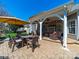Back patio includes ceiling fans, brick flooring, fireplace, seating area, and a dining table at 9727 Glenburn Ln, Charlotte, NC 28278