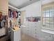 Spacious walk-in closet with custom shelving, drawers, and ample storage space at 9727 Glenburn Ln, Charlotte, NC 28278