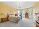 Spacious bedroom with four-poster bed, chandelier, and lots of natural light at 101 E Main St, Cleveland, NC 27013