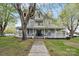 Inviting two-story home with a charming wrap-around porch, mature trees, and meticulous landscaping at 101 E Main St, Cleveland, NC 27013