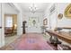 Bright foyer features a pink rug, chandelier, and original architectural details at 101 E Main St, Cleveland, NC 27013