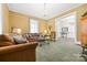 Inviting living room with plush seating, decorative chandelier, and open doorway to an adjoining room at 101 E Main St, Cleveland, NC 27013