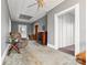 An open living room, with a fireplace, neutral paint, a ceiling fan, and natural light at 101 E Main St, Cleveland, NC 27013