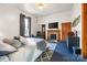 This spacious bedroom features a fireplace, flat screen tv, a ceiling fan, and an updated en suite bathroom at 101 E Main St, Cleveland, NC 27013
