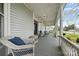 Inviting porch with wicker furniture, a cozy seating area, and charming decorative accents at 101 E Main St, Cleveland, NC 27013