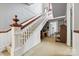 Staircase with a wooden handrail and light-colored carpet at 101 E Main St, Cleveland, NC 27013