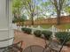 Inviting backyard patio with brick flooring, seating, and a white picket fence at 1018 Davant Ln, Charlotte, NC 28209
