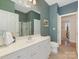 A full bathroom features double sinks, a large mirror, and a shower with glass doors at 1018 Davant Ln, Charlotte, NC 28209