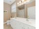 A full bathroom boasts double sinks, a large mirror, and ample lighting at 1018 Davant Ln, Charlotte, NC 28209