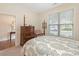Relaxing bedroom showcasing a four-poster bed and a view of the outside through the window at 1018 Davant Ln, Charlotte, NC 28209
