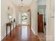 Bright entryway featuring hardwood floors, a decorative mirror, and a view into the adjacent bedroom at 1018 Davant Ln, Charlotte, NC 28209