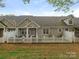 Charming townhome exterior featuring a well-maintained yard and white picket fence at 1018 Davant Ln, Charlotte, NC 28209