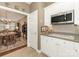 This kitchen features white cabinets, a stainless steel microwave, and tile flooring at 1018 Davant Ln, Charlotte, NC 28209