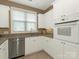 Modern kitchen featuring white cabinets, stainless steel appliances, and a granite countertop at 1018 Davant Ln, Charlotte, NC 28209