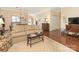 Spacious living room showcasing a large sofa, hardwood floors, and seamless flow to the dining area and kitchen at 1018 Davant Ln, Charlotte, NC 28209