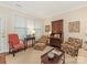 Cozy sitting room with patterned armchairs, a wooden desk, and a large window offering natural light at 1018 Davant Ln, Charlotte, NC 28209