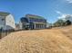 Large backyard with a black fence and patio visible from this angle at 104 Hemlock Cove Ct, Mooresville, NC 28117
