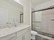 This bathroom features a granite countertop, glass shower door, and an undermount sink at 104 Hemlock Cove Ct, Mooresville, NC 28117