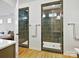 Contemporary bathroom showcasing a glass-enclosed tiled shower and a separate, spacious shower at 104 Hemlock Cove Ct, Mooresville, NC 28117