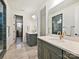 Modern bathroom with double vanities, elegant fixtures, and a tiled floor, providing a spa-like experience at 104 Hemlock Cove Ct, Mooresville, NC 28117